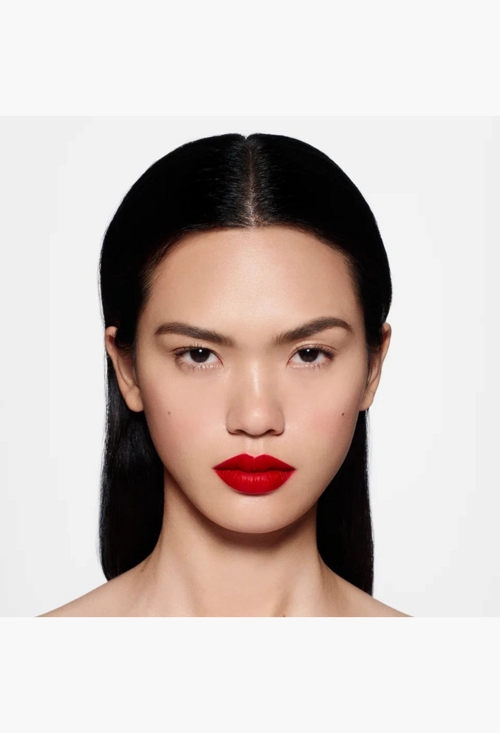 Model wearing GLAM MODA Rouge Victoria matte red lipstick with a bold, saturated finish and smooth, velvety texture.