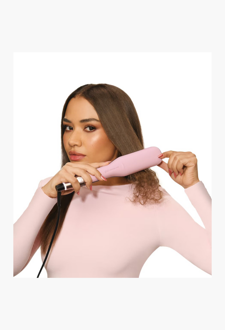 GLAM MODA model using a pink ghd Chronos Max wide plate hair straightener to style long, smooth hair.