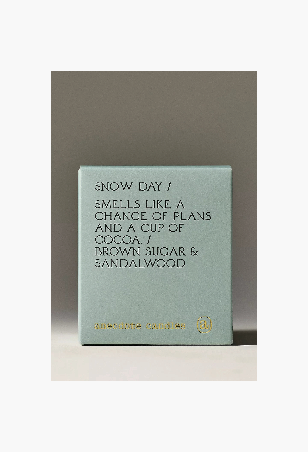 GLAM MODA Anecdote Gourmand Snow Day candle in a sage green box with brown sugar and sandalwood scent description