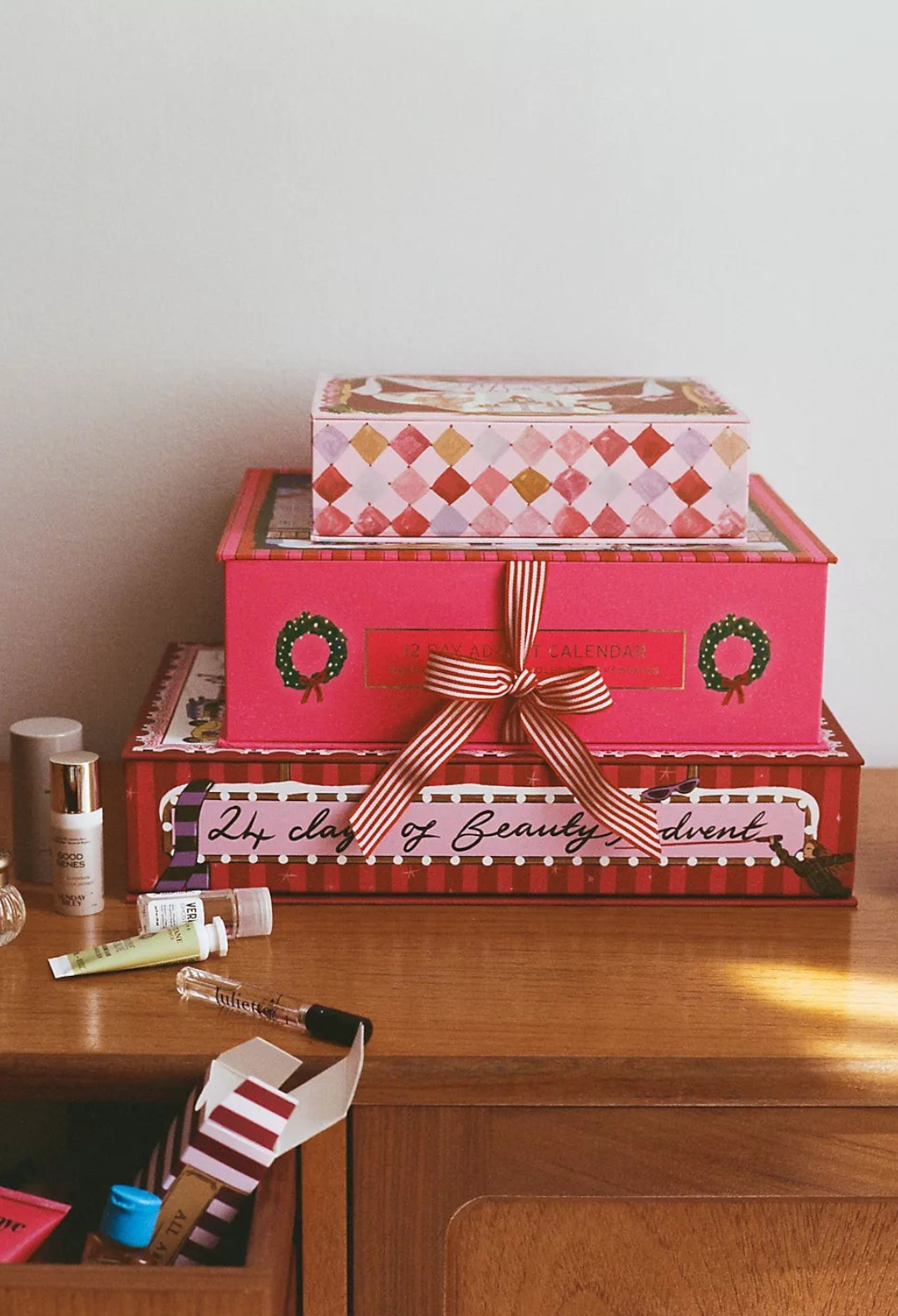 GLAM MODA 24 Days of Beauty Advent Calendar with whimsical Nephthys Foster illustrations and assorted skincare samples.