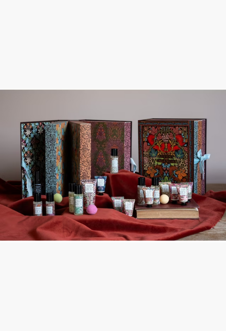 GLAM MODA William Morris At Home 2026 beauty advent calendar with 24 vegan bath and body gifts on red velvet fabric