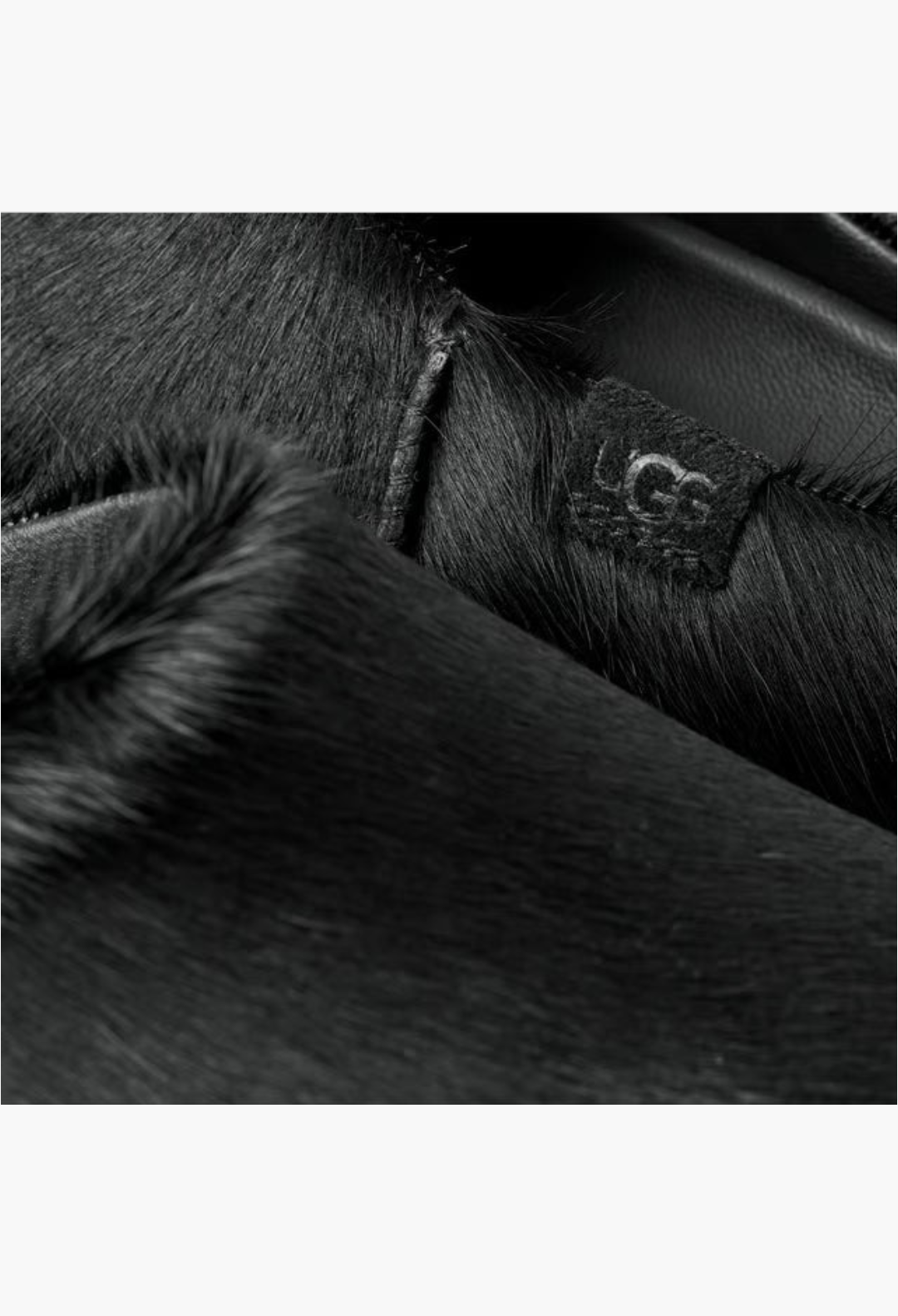 GLAM MODA Otzo black calf hair clog featuring a detailed view of the textured upper and embossed UGG logo leather tag