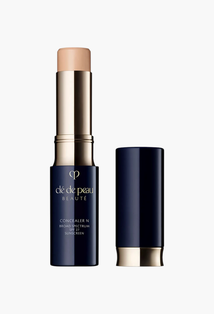 GLAM MODA Concealer SPF 27 stick in a navy and gold tube with the cap removed to show the creamy beige product.