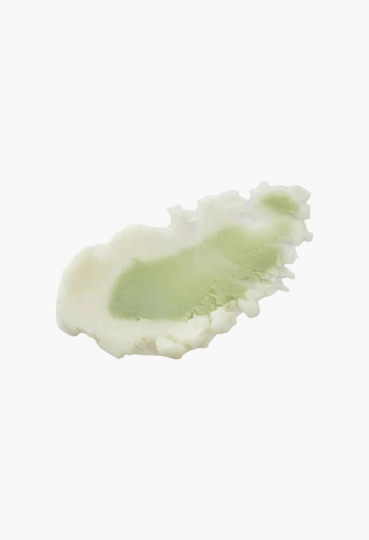 GLAM MODA Dinsee vegan sunscreen stick texture swatch showing a smooth, lightweight pale green and white cream blend.
