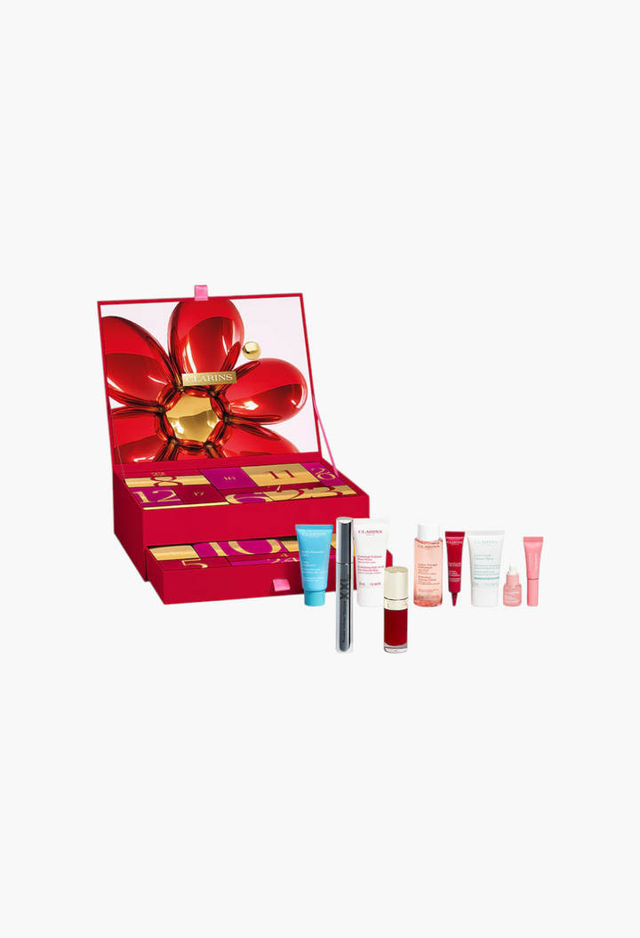 GLAM MODA Clarins 24-day beauty advent calendar with red floral box, skincare, and makeup products displayed.
