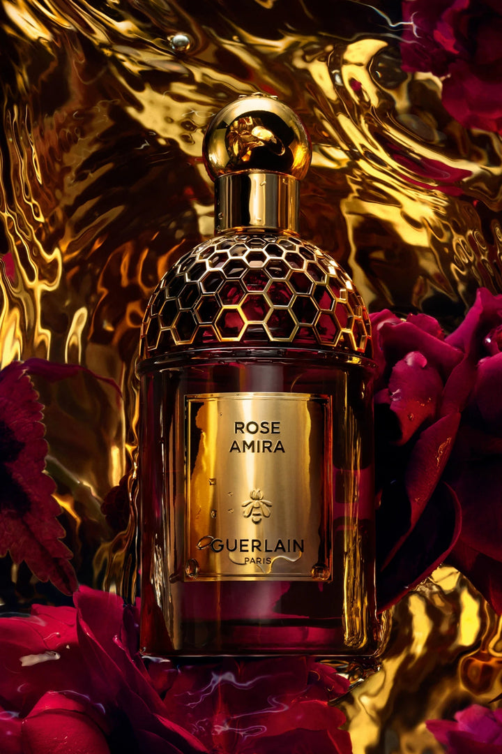 GLAM MODA Guerlain Rose Amira Eau De Parfum in a deep red glass bottle with a gold honeycomb cap and label.