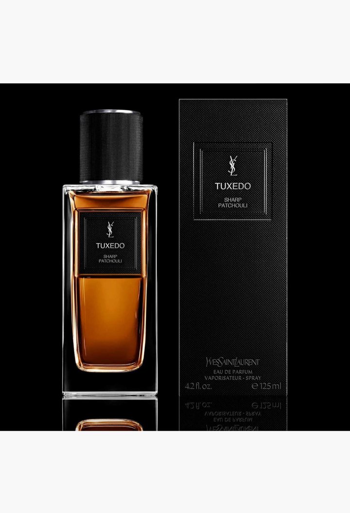 GLAM MODA Yves Saint Laurent Tuxedo Sharp Patchouli perfume bottle and black textured box on a reflective surface