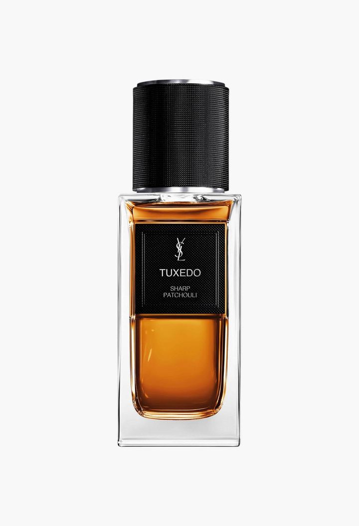 GLAM MODA Yves Saint Laurent Tuxedo Sharp Patchouli perfume bottle with amber liquid and a textured black cap.