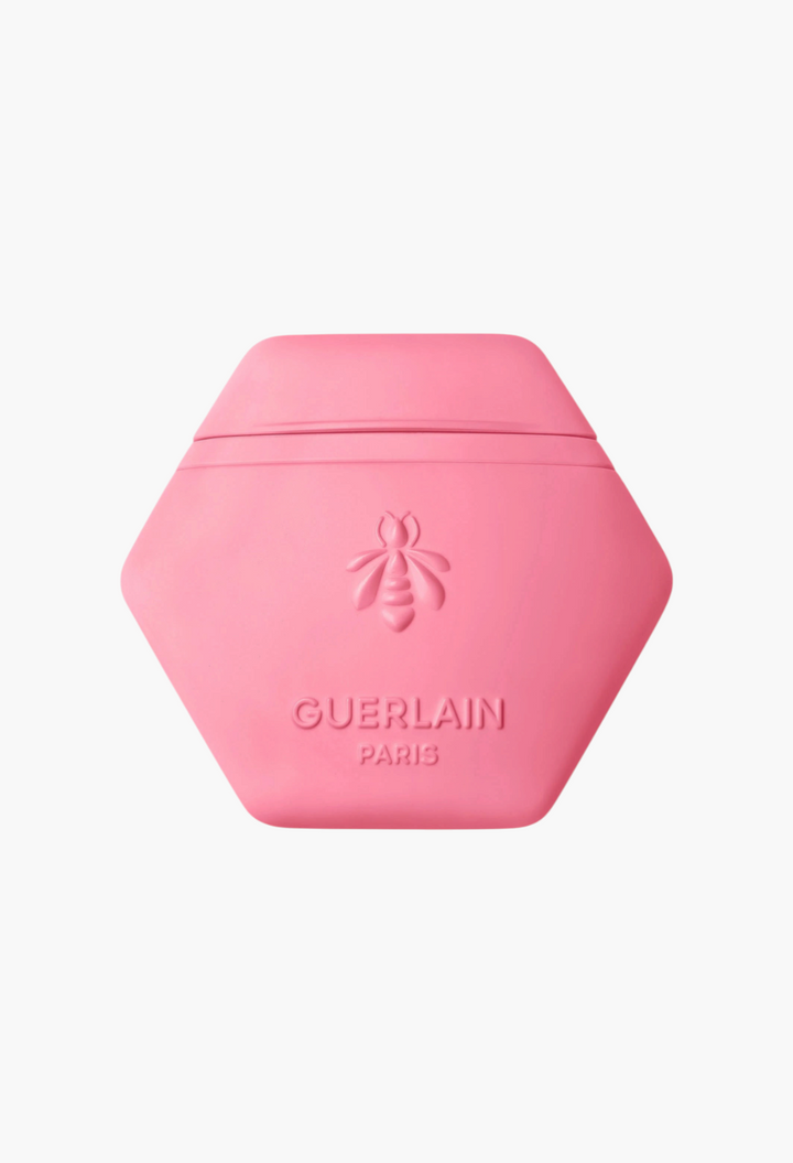 GLAM MODA Guerlain Aqua Allegoria Florabloom hand cream in a pink honeycomb-shaped tube with embossed bee logo