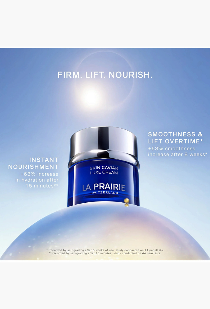 GLAM MODA La Prairie Skin Caviar Luxe Cream in a signature cobalt blue glass jar with a silver cap against a sunlit sky