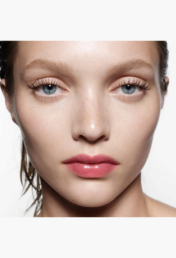 GLAM MODA Posh Balm Nourishing Lip Shine on a model, showcasing a glossy, sheer pink finish and hydrated lips.