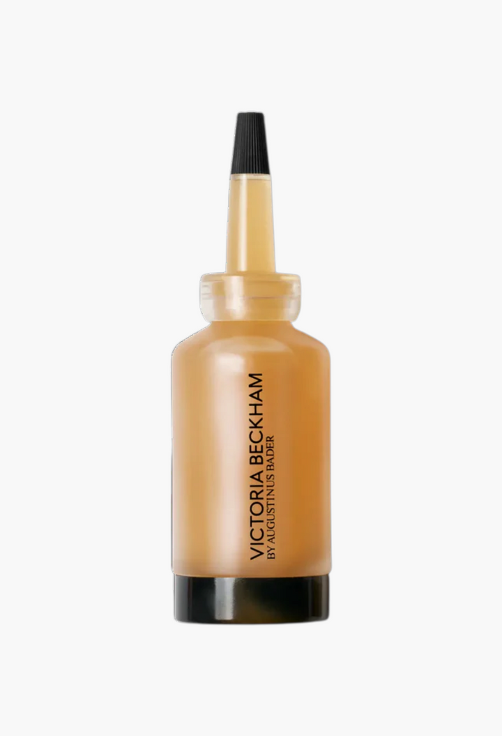 GLAM MODA Victoria Beckham by Augustinus Bader Cell Rejuvenating Power Serum in a sleek amber bottle with black cap.