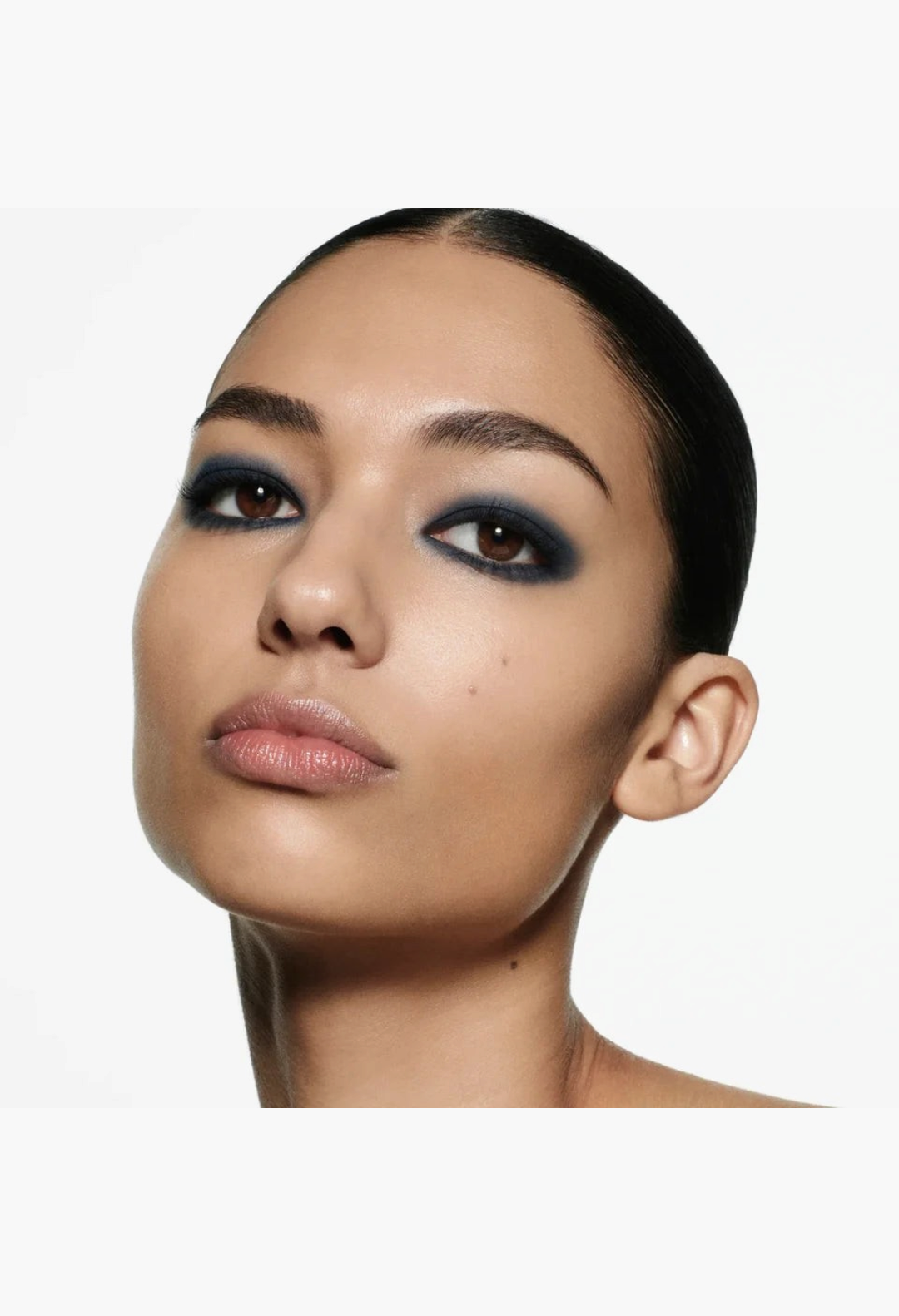 Model wearing a bold, smoky navy blue eye look created with the GLAM MODA Eye Wardrobe Multi-Finish Eyeshadow Palette