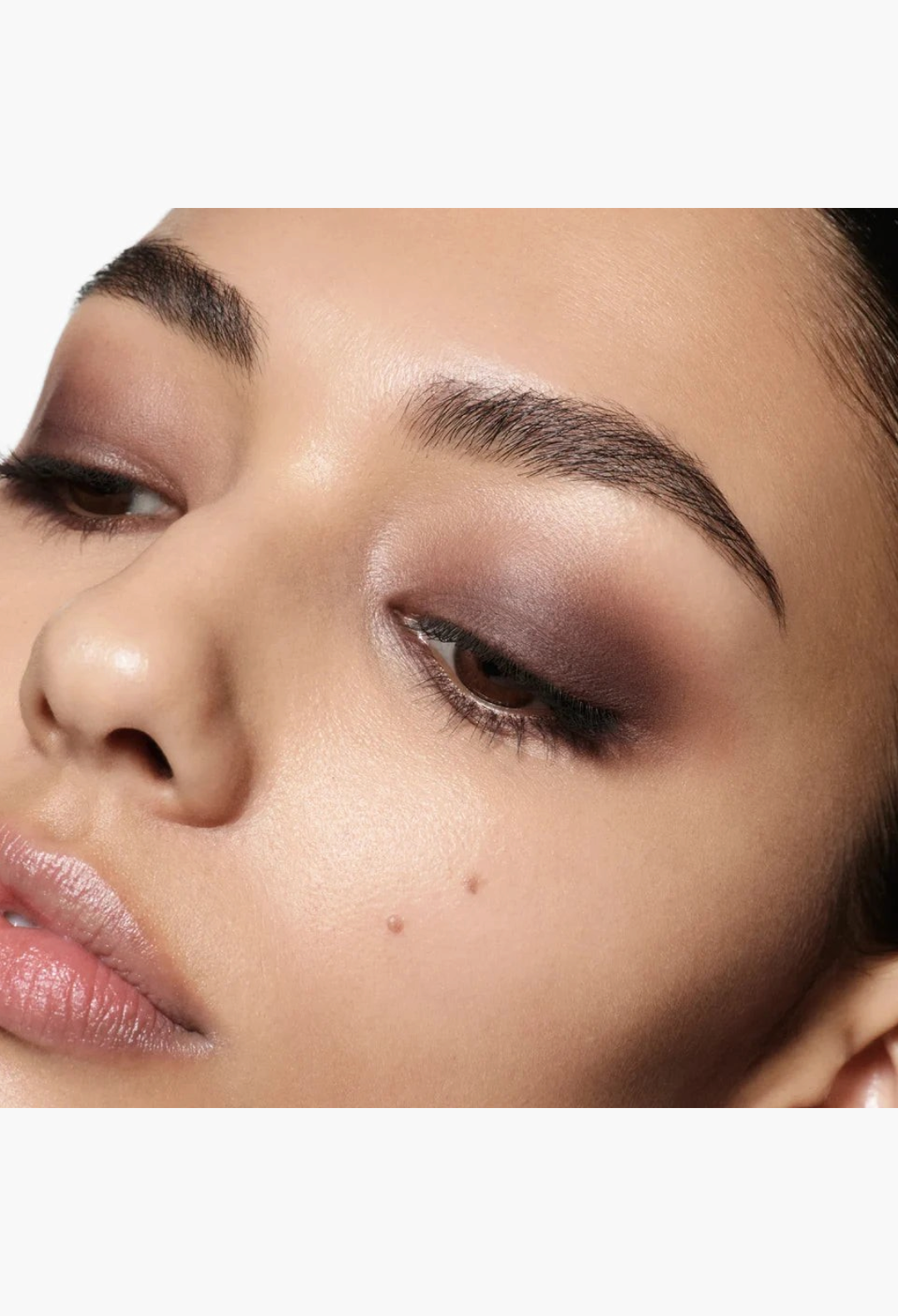 Close-up of a model wearing a smoky brown eyeshadow look created with the GLAM MODA Eye Wardrobe palette