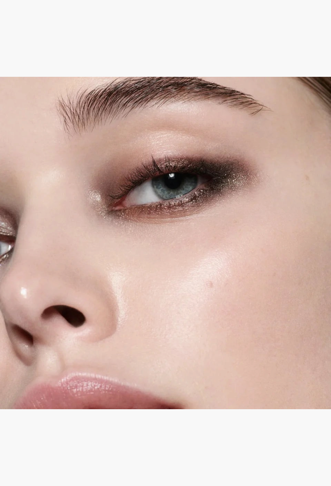 Close-up of a model wearing GLAM MODA Eye Wardrobe Night Flash eyeshadow palette with shimmering and matte brown tones