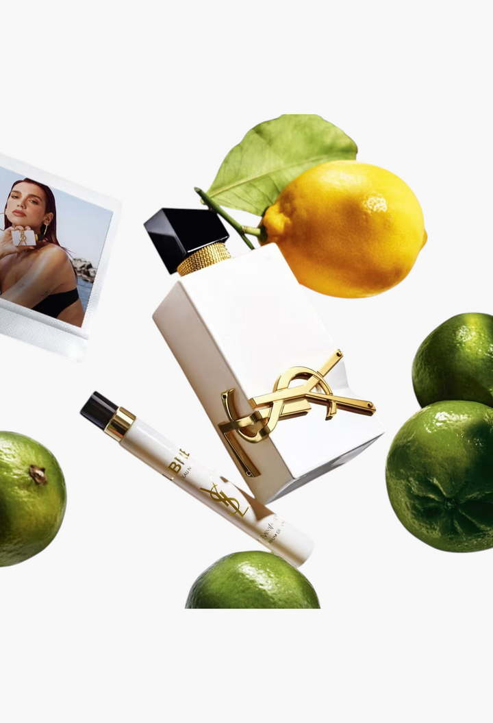 GLAM MODA Yves Saint Laurent Libre L’Eau Nue perfume bottle and travel spray surrounded by fresh citrus fruits