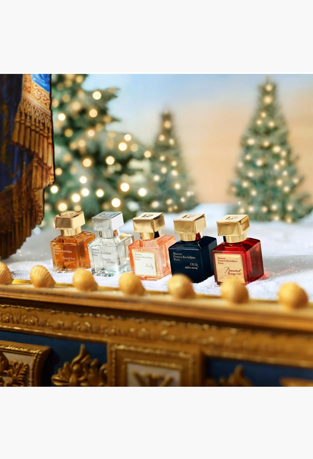 GLAM MODA Maison Francis Kurkdjian miniatures gift set featuring five iconic glass perfume bottles on snowy surface.
