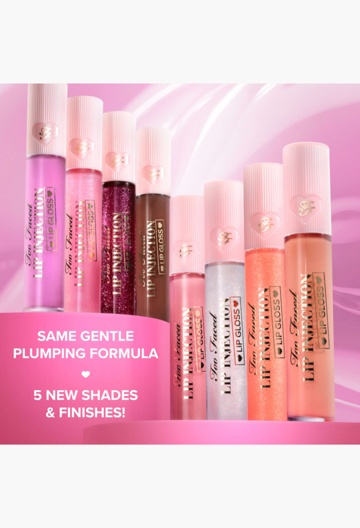 GLAM MODA Lip Injection Power Plumping Lip Gloss collection in various shades and high-shine finishes on a pink stand.