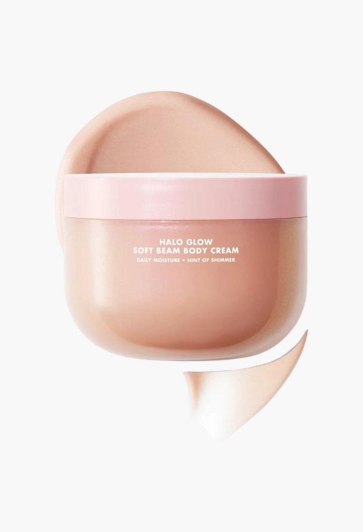 GLAM MODA Halo Glow Soft Beam Body Cream in a jar with a pink lid and a creamy, shimmering product swatch behind it.