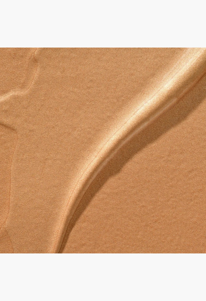 GLAM MODA Hyper Shine Lite Pigment swatch showing a creamy, radiant gold shimmer texture for face and body.