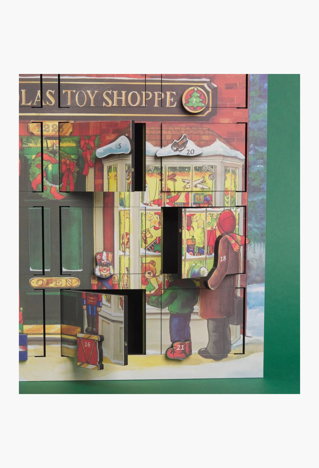 GLAM MODA wooden advent calendar featuring a festive toy shop scene with 24 numbered doors for holiday treats.
