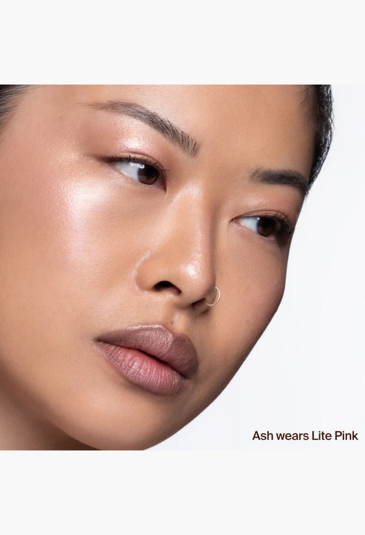 GLAM MODA Hyper Shine Lite Pigment in Lite Pink applied to a model's cheekbones for a radiant glass skin glow