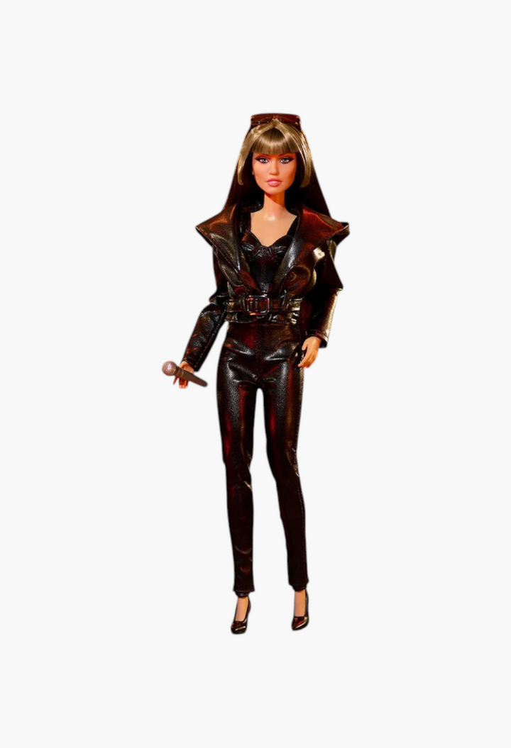 GLAM MODA collectible Miley Cyrus Barbie doll wearing a black faux-leather outfit with a microphone on a stage