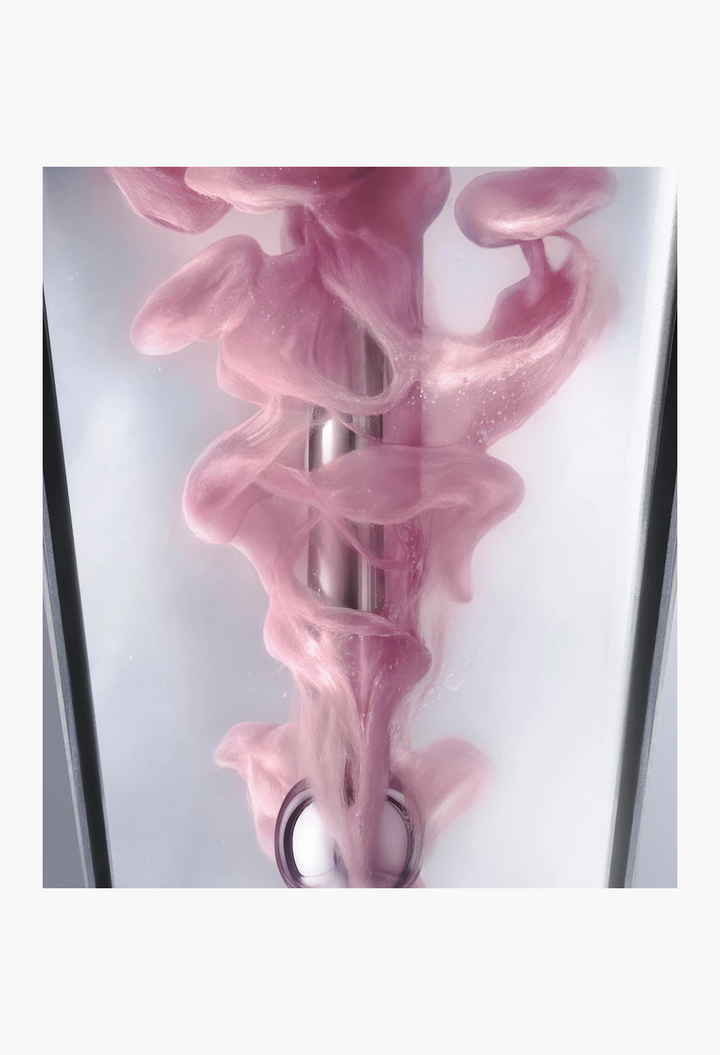 GLAM MODA Platinum Rare Haute-Rejuvenation Protocol serum blending with swirling pink liquid in a glass vial