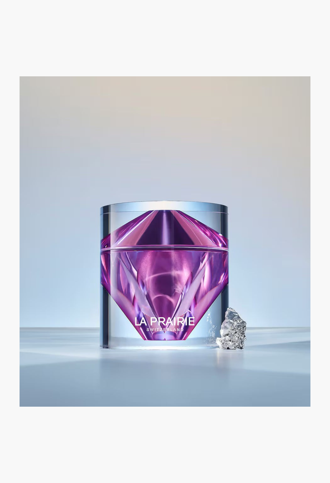 GLAM MODA La Prairie Platinum Rare Haute-Rejuvenation Cream in a faceted purple glass jar with a metallic accent.