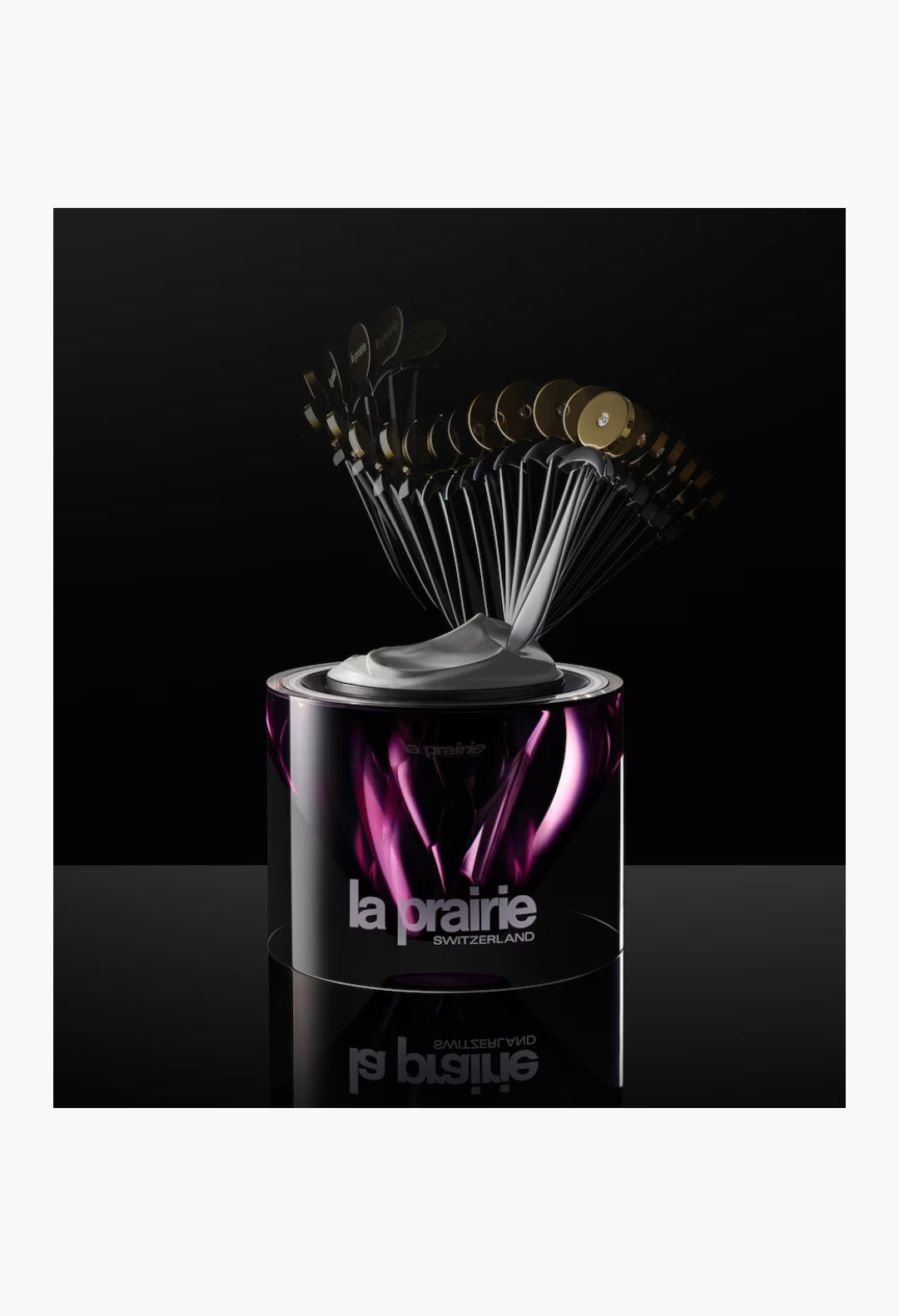 GLAM MODA La Prairie Platinum Rare Haute-Rejuvenation Cream in a sleek purple jar with a fan of application spatulas.