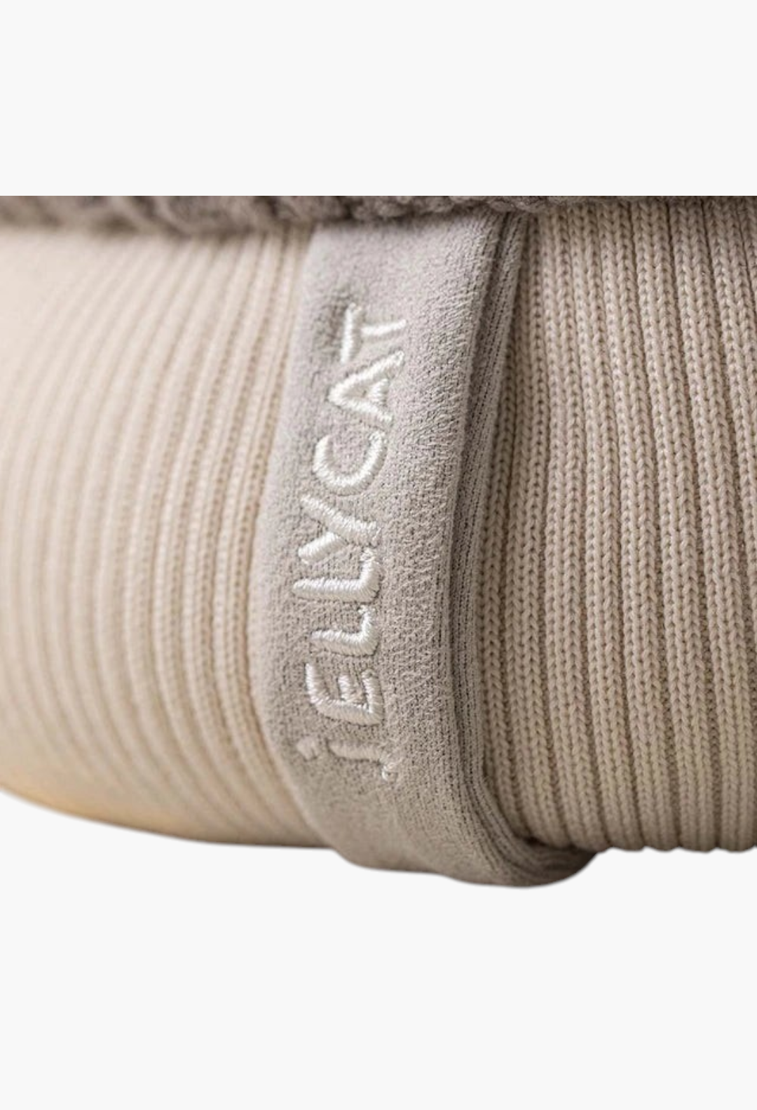 Close-up of GLAM MODA Amuseables Pomilly plush toy showing ribbed beige texture and embroidered Jellycat logo tag