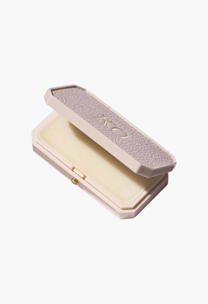 GLAM MODA Baume des Muses Ivory lip balm in a textured, customizable case with gold embossed initials.