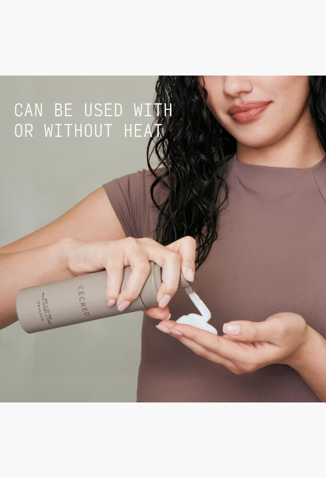 GLAM MODA Wrap & Set Foam being dispensed into a woman's hand for styling damp hair