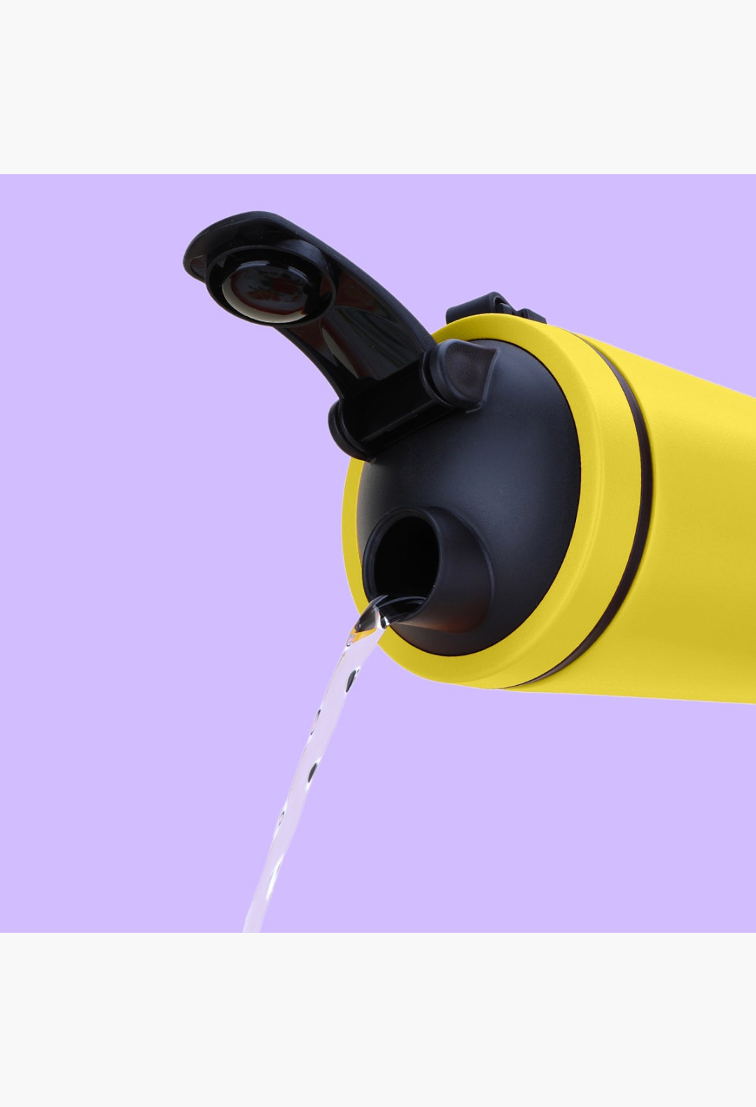 GLAM MODA yellow stainless steel insulated shaker bottle with black lid pouring water against a light purple background