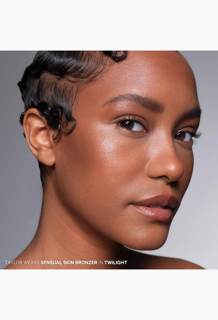 GLAM MODA model wearing The Sensual Skin Bronzer in Twilight shade for a radiant, sun-kissed, and airbrushed finish.