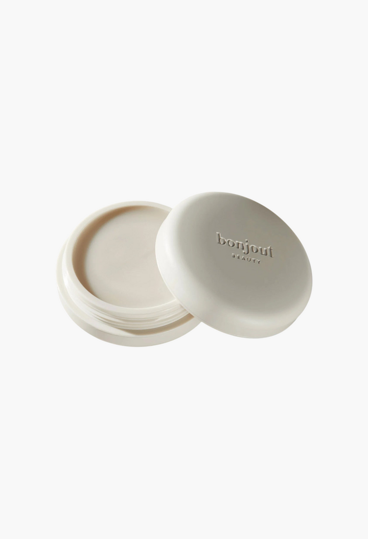 GLAM MODA Le Balm unscented solid serum in a white jar with lid, featuring natural skincare certification icons.