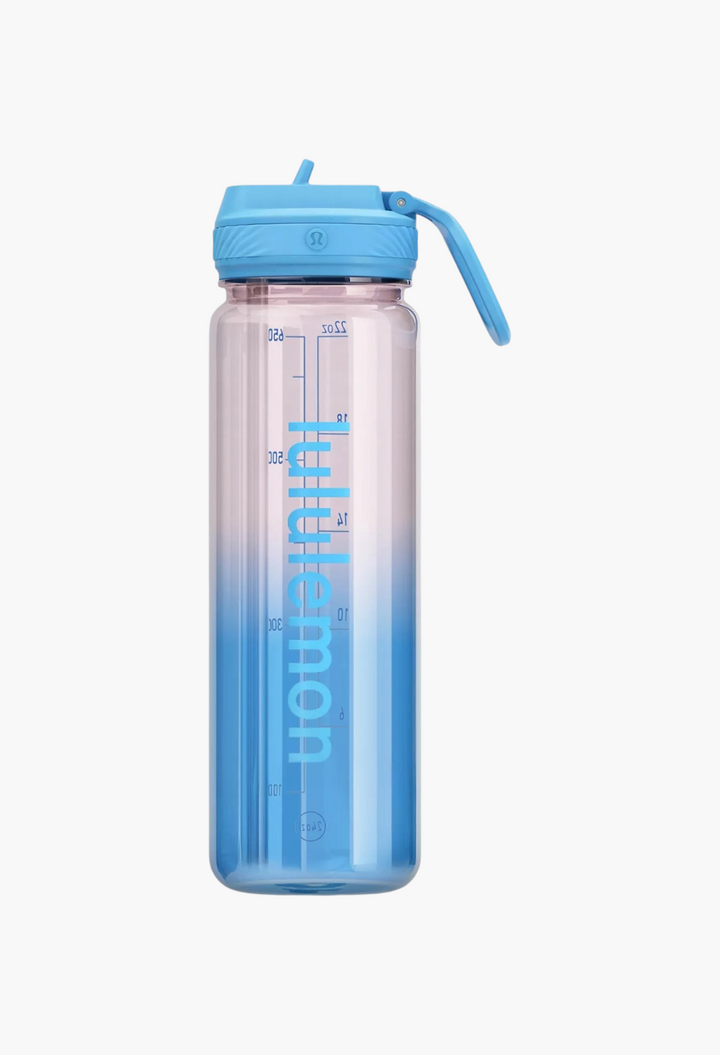 GLAM MODA 24oz clear Tritan water bottle with a blue ombre finish, straw lid, and vertical logo branding.