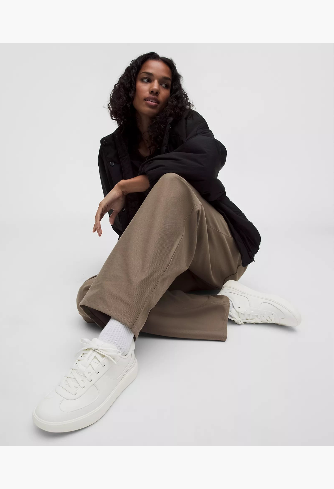 GLAM MODA Women's Cityverse white leather-alternative sneakers with exposed stitching worn by a model in casual attire