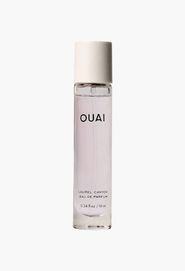 GLAM MODA travel-sized OUAI Laurel Canyon Eau de Parfum in a slim glass spray bottle with a white cap.