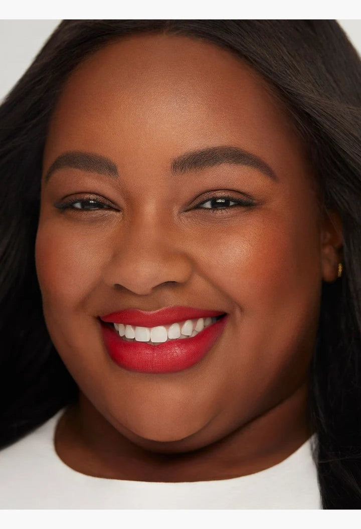 GLAM MODA Kind Words matte lip liner in Devoted true red shade applied on a smiling model with a soft matte finish