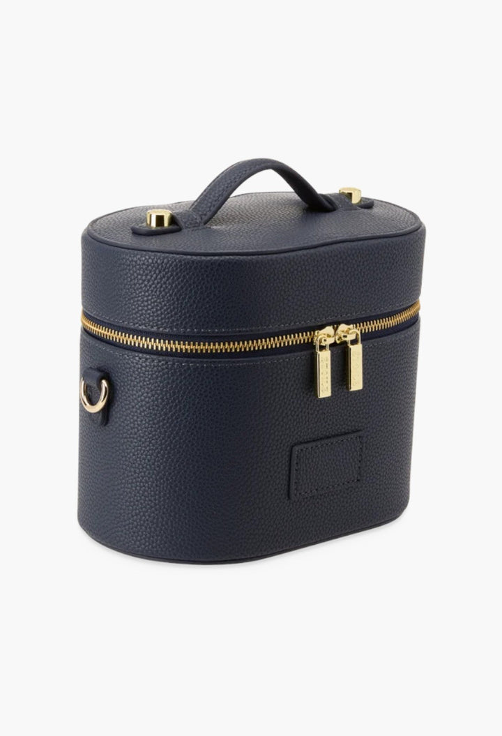GLAM MODA navy blue oval vegan leather toiletry case with gold hardware, top handle, and dual zipper closure.