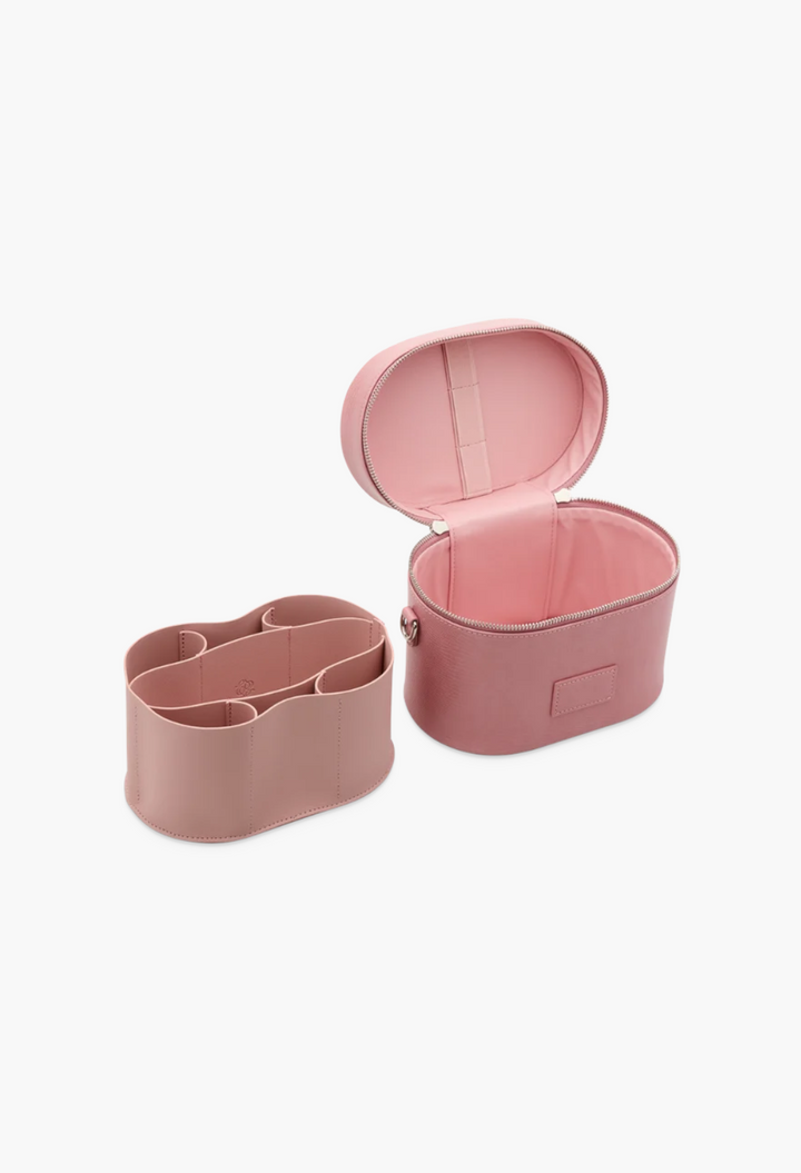 GLAM MODA pink oval vegan leather toiletry case with removable divider insert and brush storage on white background