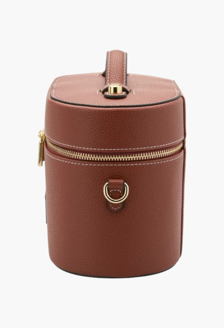 GLAM MODA brown vegan leather oval toiletry case with gold zipper hardware and a top handle on a white background.
