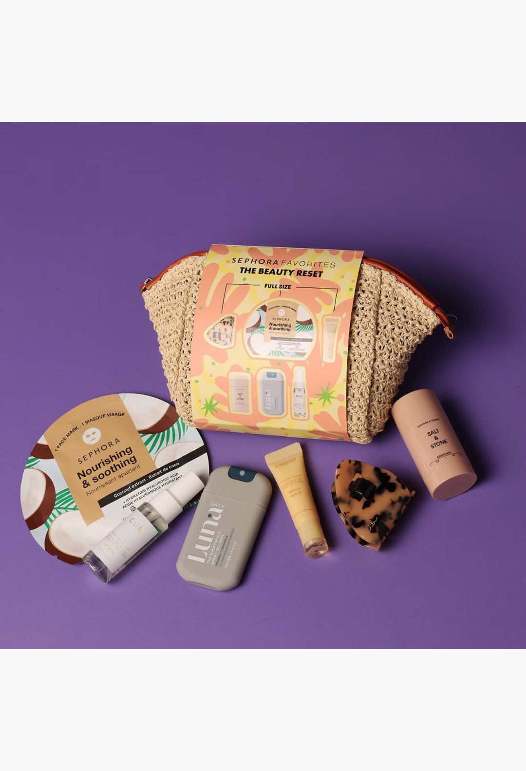 GLAM MODA The Beauty Reset wellness kit featuring skincare, hair accessories, and body care products in a straw pouch.