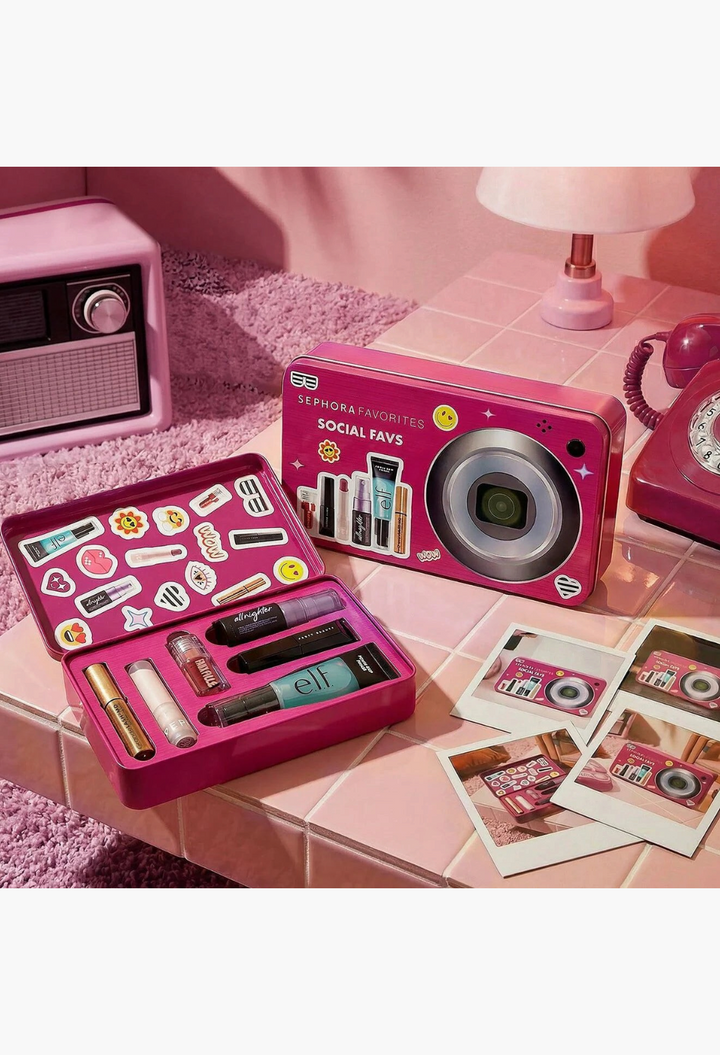 GLAM MODA Social Favs 2026 beauty kit in a pink camera-shaped tin with makeup essentials on a tiled surface