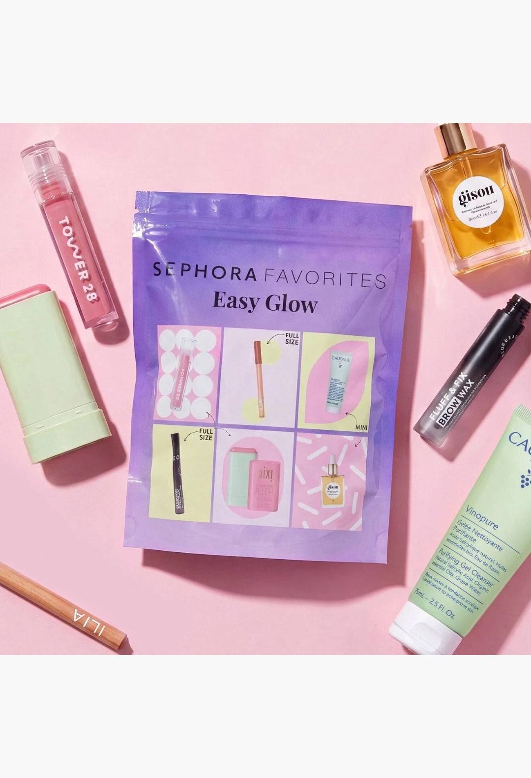 GLAM MODA Easy Glow beauty set featuring skincare, lip gloss, brow wax, blush, and hair oil on a pink background.