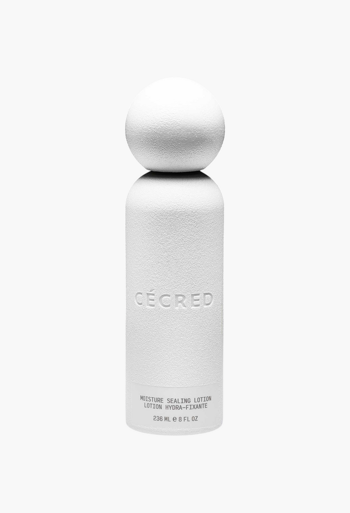 GLAM MODA Moisture Sealing Lotion in a white cylindrical bottle with a spherical cap against a black background.