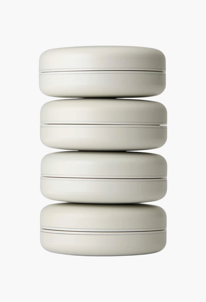 GLAM MODA Le Balm Quatre solid serum set featuring four stacked beige compact containers for skincare.