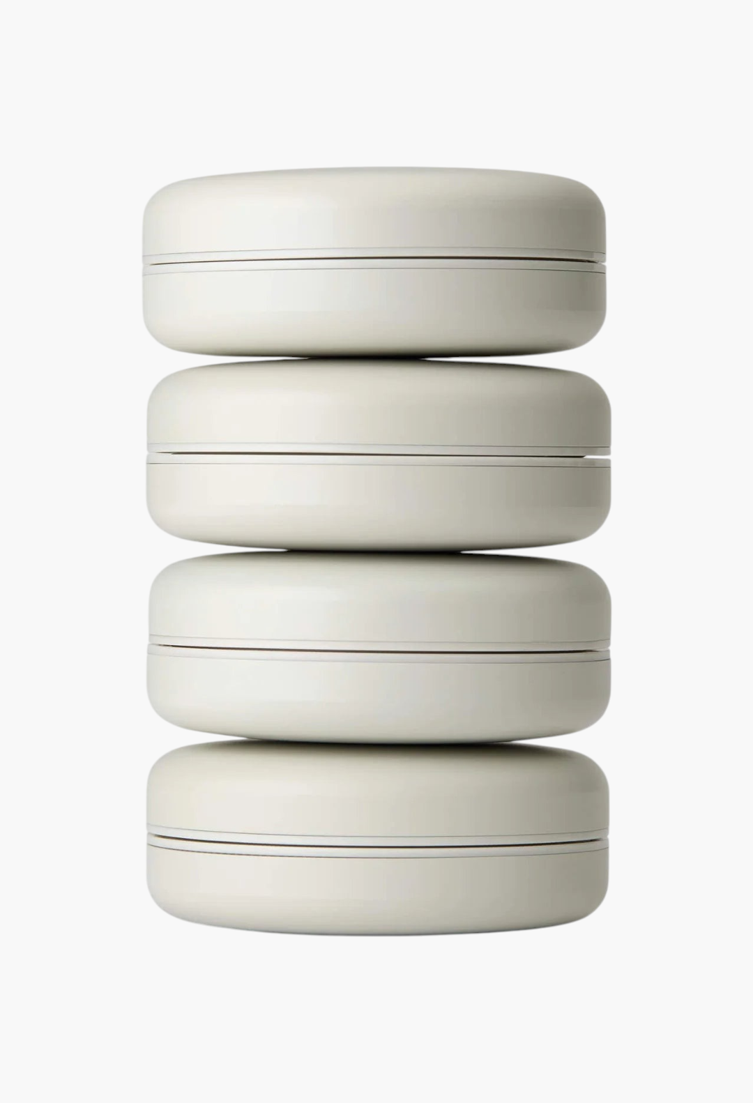 GLAM MODA Le Balm Quatre set of four unscented solid serum compacts stacked vertically on a white background.