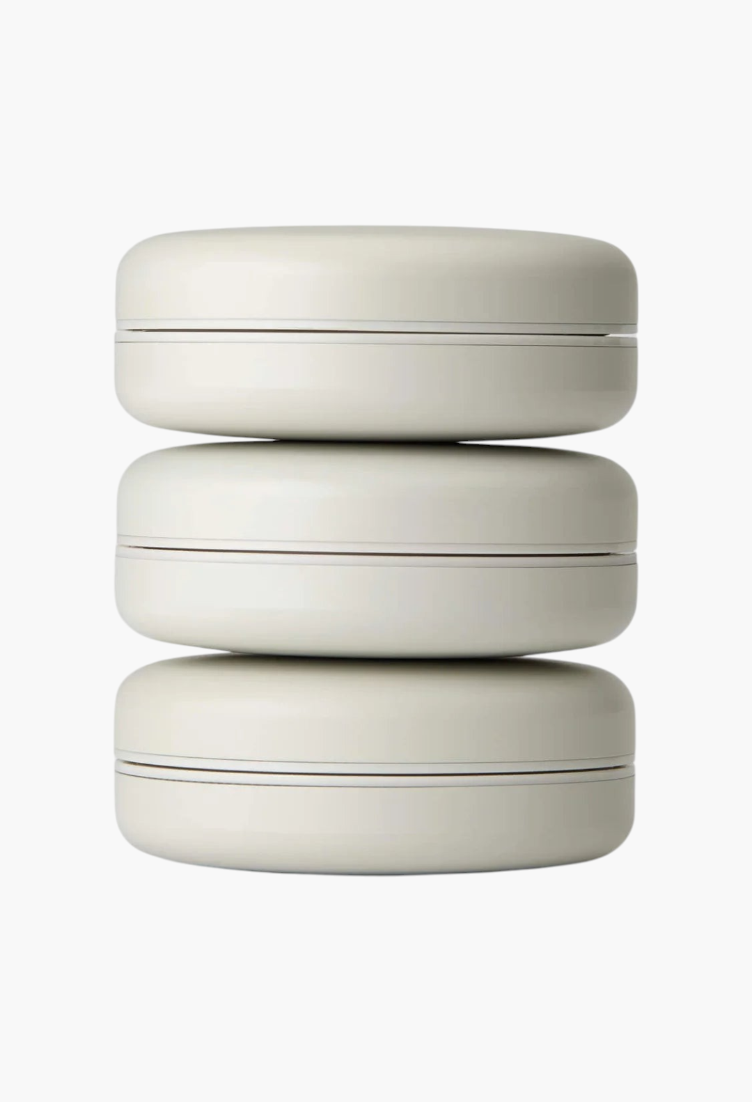 GLAM MODA Le Balm Trois solid serum trio in sleek beige compacts stacked vertically on a white background